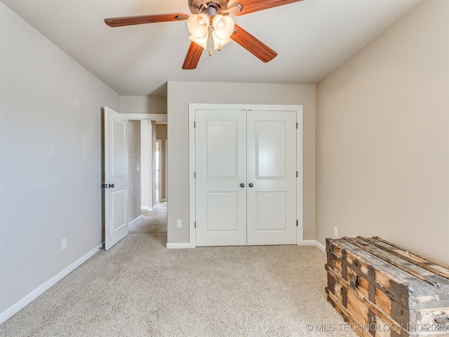 unfurnished bedroom featuring carpet, baseboards, and a closet