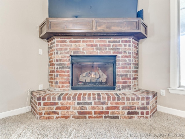 interior details featuring a brick fireplace, carpet flooring, and baseboards