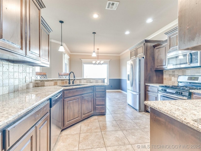 kitchen with light tile patterned floors, visible vents, appliances with stainless steel finishes, crown molding, and a sink