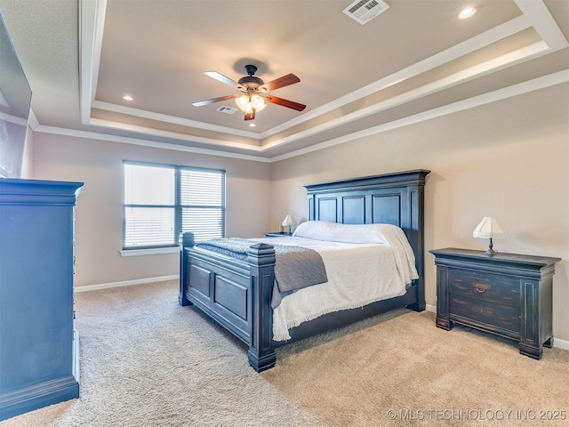 bedroom featuring baseboards, a raised ceiling, visible vents, and light colored carpet