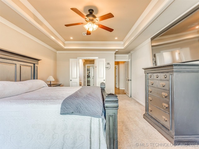 bedroom with recessed lighting, light colored carpet, visible vents, ornamental molding, and a tray ceiling