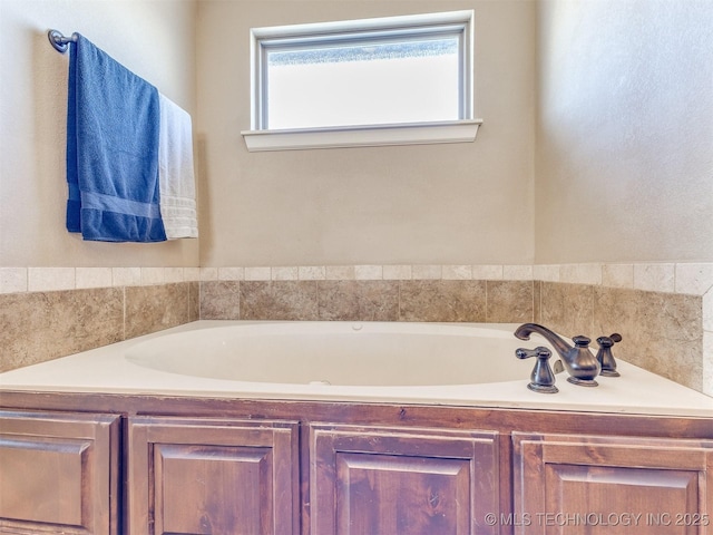 bathroom with a garden tub