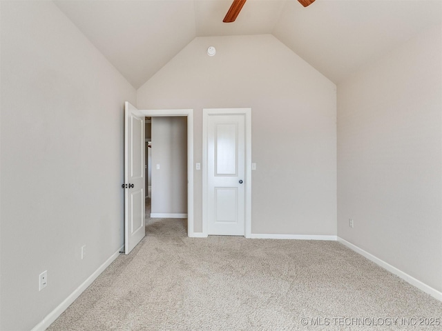 unfurnished bedroom with vaulted ceiling, baseboards, a ceiling fan, and light colored carpet