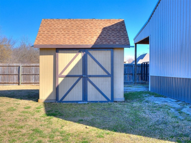 view of shed with a fenced backyard