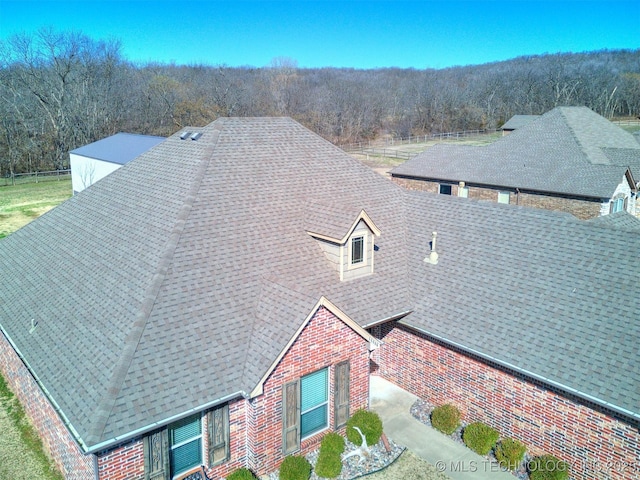 drone / aerial view featuring a forest view