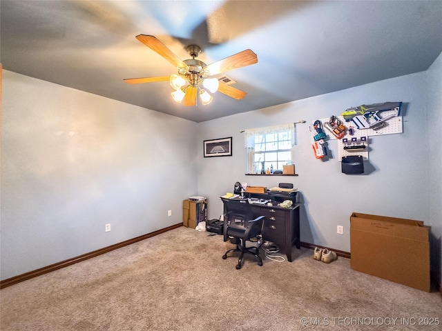 carpeted home office featuring baseboards, visible vents, and a ceiling fan