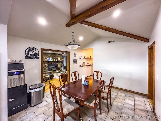 dining room featuring visible vents, vaulted ceiling with beams, and baseboards