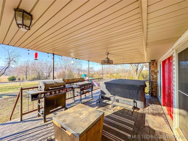 wooden terrace featuring a hot tub and grilling area