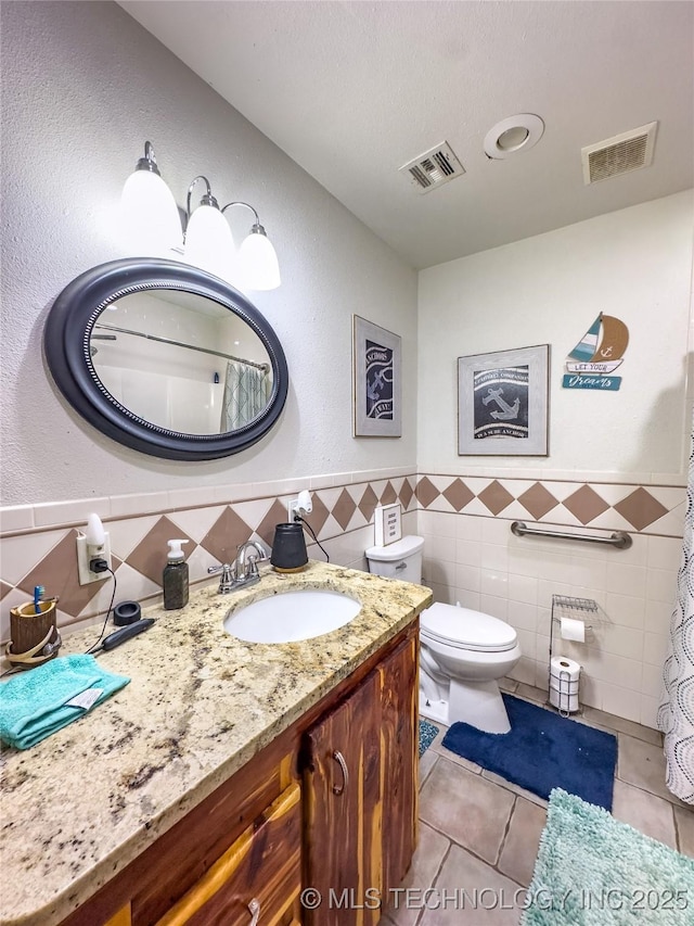 full bath with toilet, vanity, tile patterned flooring, and visible vents