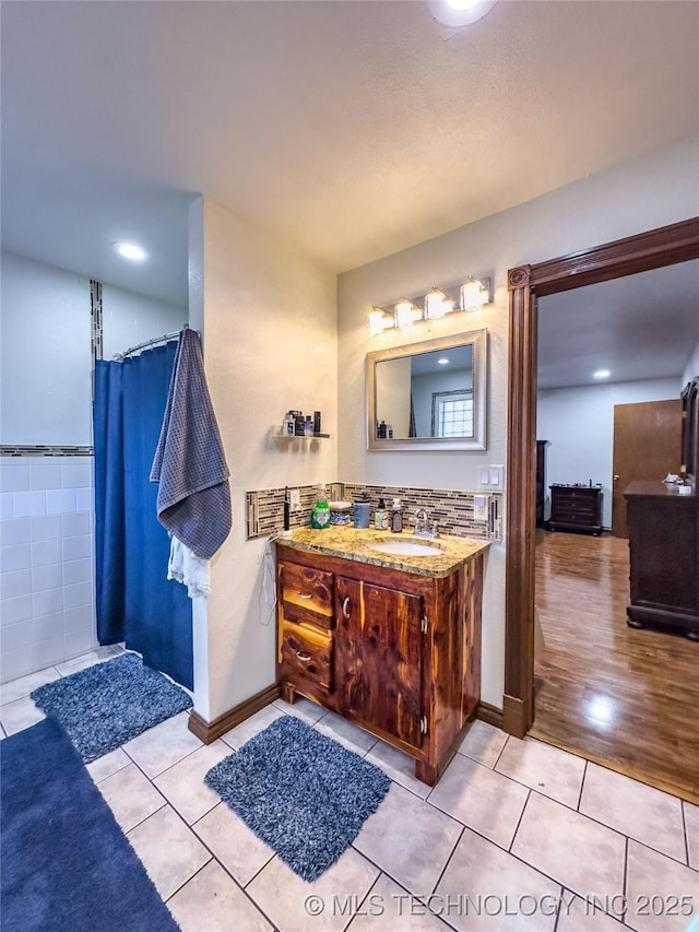 full bathroom featuring tile patterned flooring and vanity