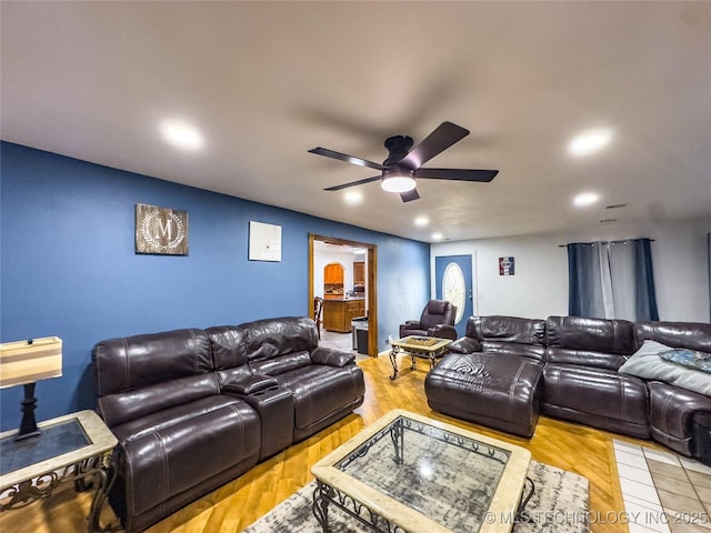 cinema featuring ceiling fan and wood finished floors