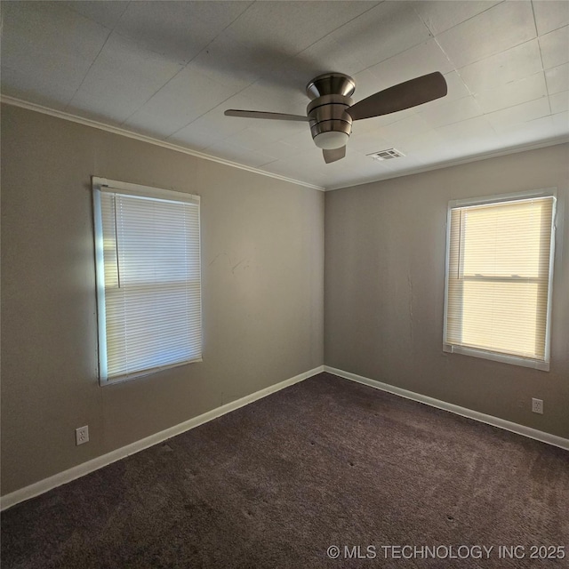 unfurnished room featuring carpet floors, visible vents, ornamental molding, ceiling fan, and baseboards