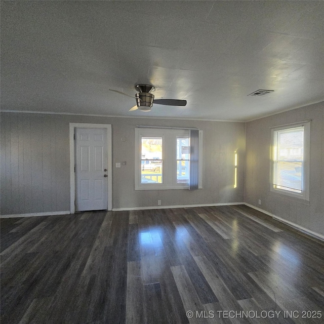 unfurnished living room with a ceiling fan, baseboards, visible vents, and wood finished floors