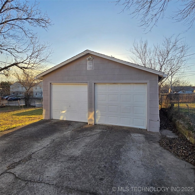 detached garage featuring fence