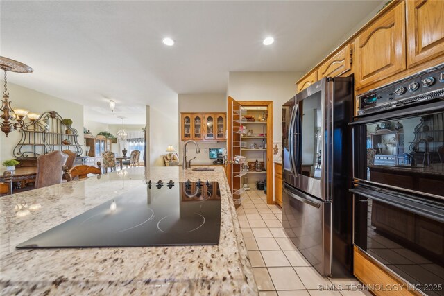 63320 E 293rd Rd, Grove, OK 74344 - kitchen featuring dobule oven black, smart refrigerator, a notable chandelier, and light stone counters