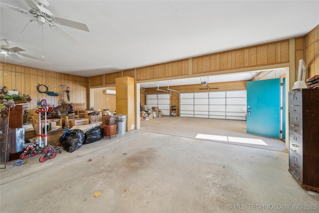 63320 E 293rd Rd, Grove, OK 74344 - garage featuring wooden walls, ceiling fan, and a garage door opener