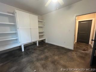 64 Crescent, Ardmore, OK 73401 - unfurnished office with a ceiling fan, baseboards, and concrete floors