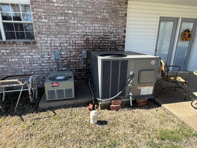 details with central air condition unit and brick siding