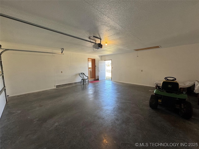 garage featuring a garage door opener and baseboards