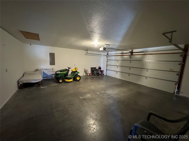 garage with a garage door opener and electric panel