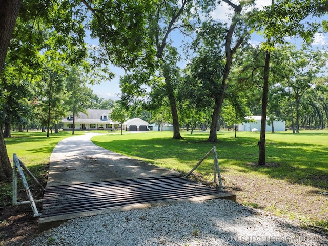 exterior space with gravel driveway and a yard