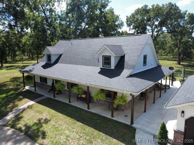 country-style home featuring a patio, a front lawn, and a shingled roof