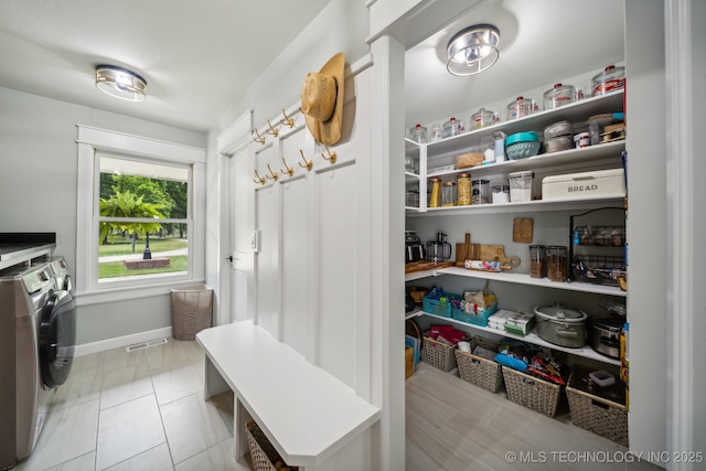 pantry featuring visible vents and separate washer and dryer