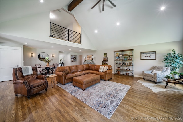 living room with recessed lighting, wood finished floors, high vaulted ceiling, beamed ceiling, and baseboards