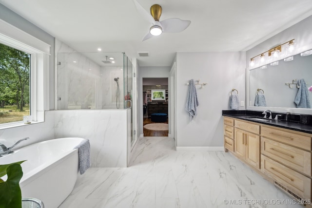 full bathroom with marble finish floor, a marble finish shower, visible vents, vanity, and a freestanding tub