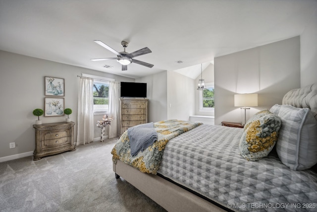 carpeted bedroom with a ceiling fan, multiple windows, vaulted ceiling, and baseboards