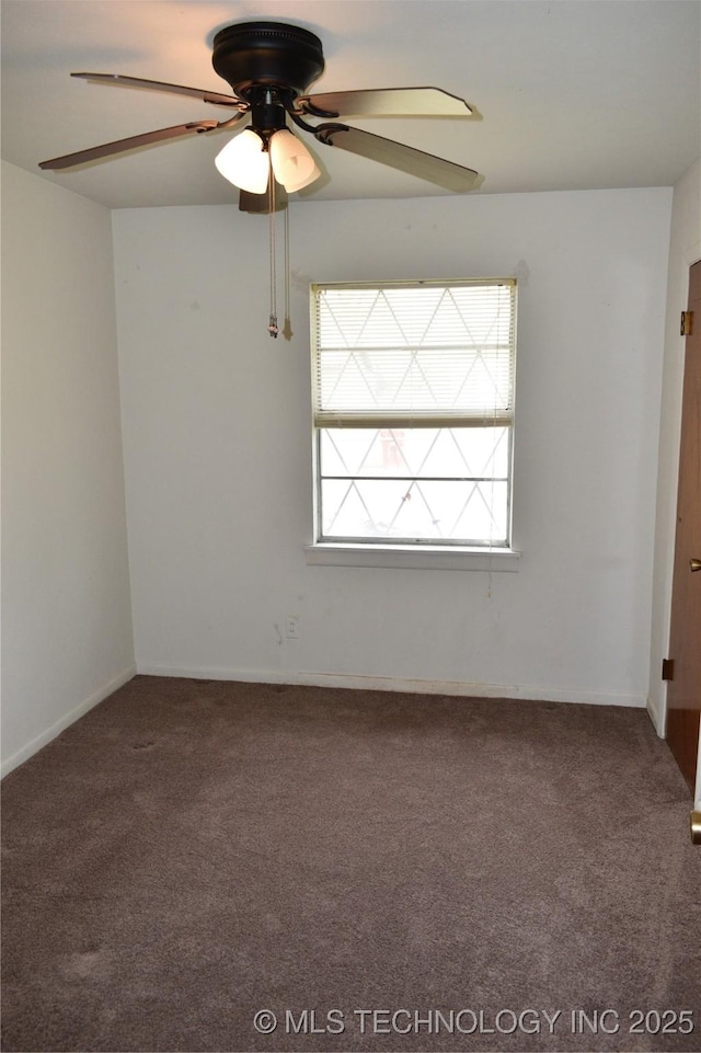 carpeted empty room featuring a ceiling fan