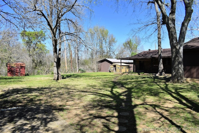 view of yard with a shed and an outbuilding