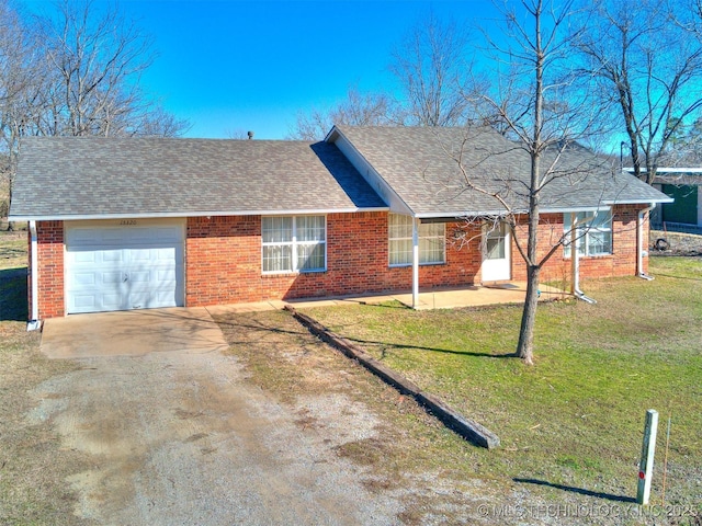 ranch-style house featuring brick siding, concrete driveway, a front yard, roof with shingles, and a garage