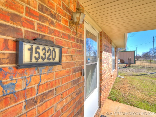 entrance to property with brick siding