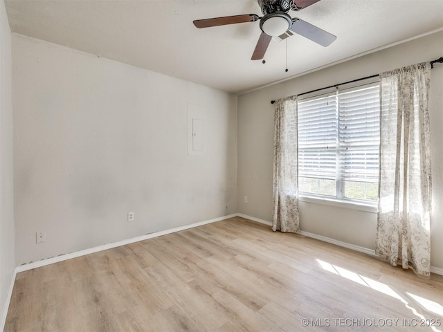 unfurnished room featuring a ceiling fan, baseboards, and wood finished floors