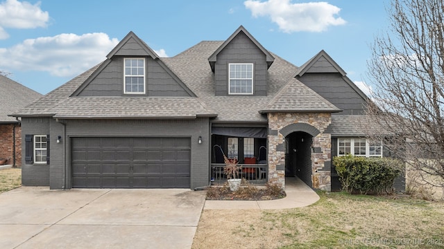 view of front of property featuring driveway, a shingled roof, a porch, and a front lawn