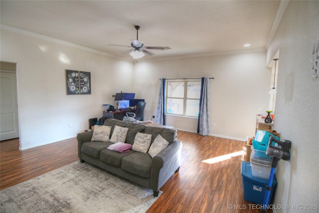 living area featuring a ceiling fan, crown molding, baseboards, and wood finished floors