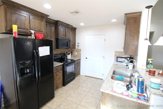 kitchen with light tile patterned flooring, a sink, visible vents, backsplash, and black appliances