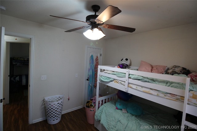 bedroom with wood finished floors, a ceiling fan, and baseboards