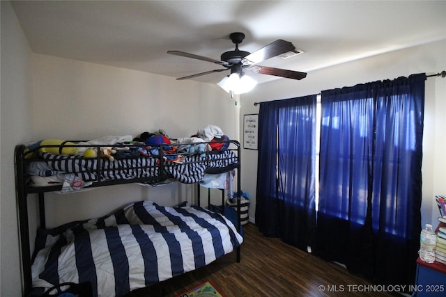 bedroom featuring visible vents, wood finished floors, and a ceiling fan