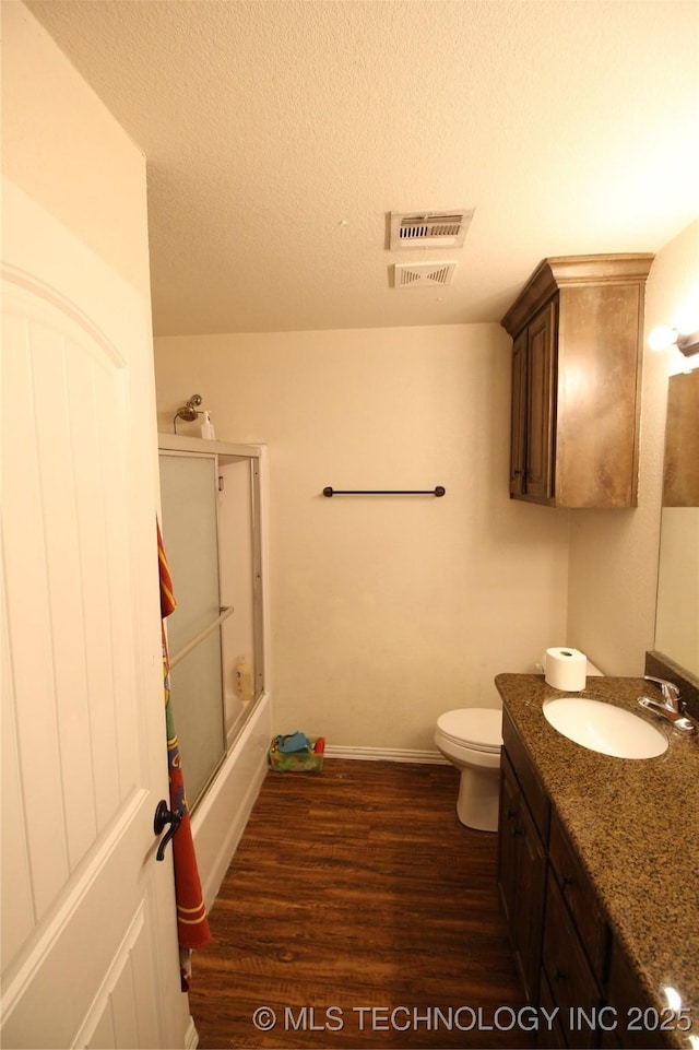 full bathroom with visible vents, vanity, a textured ceiling, and wood finished floors