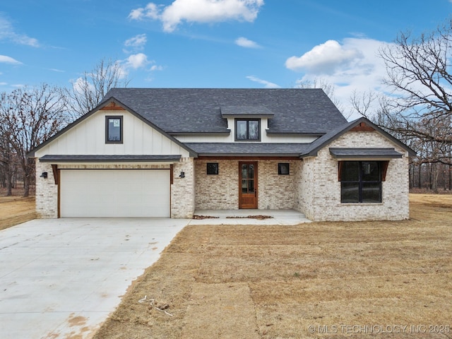 modern farmhouse with brick siding, roof with shingles, concrete driveway, a front yard, and a garage