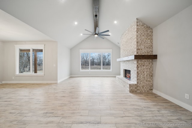 unfurnished living room featuring baseboards, a ceiling fan, lofted ceiling, light wood-style flooring, and a fireplace