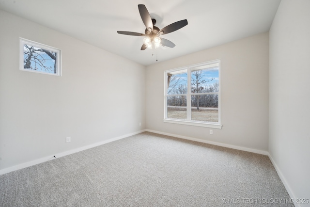 unfurnished room featuring a ceiling fan, carpet, and baseboards