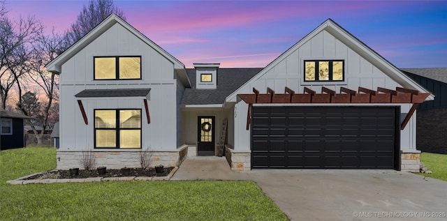 modern inspired farmhouse featuring driveway, a shingled roof, board and batten siding, and stone siding