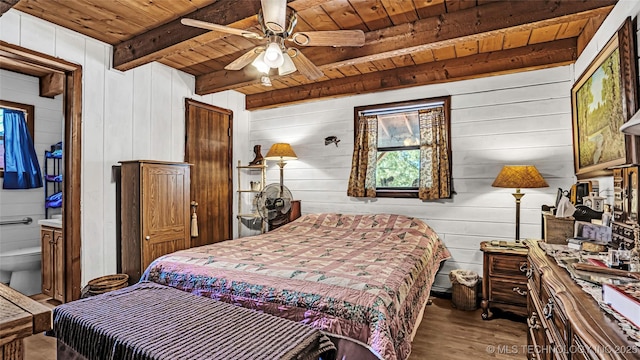 bedroom with beam ceiling, ceiling fan, connected bathroom, wood finished floors, and wooden ceiling