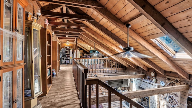 unfinished attic featuring a skylight and an upstairs landing