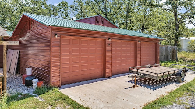 detached garage featuring fence