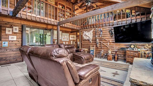 living room with high vaulted ceiling, wood walls, visible vents, tile patterned floors, and rustic walls