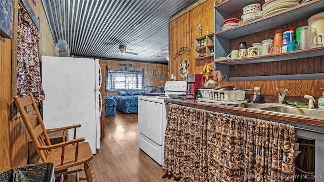 kitchen featuring open shelves, white appliances, wood finished floors, and wooden walls